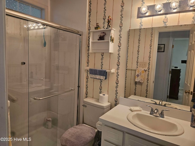 bathroom with a stall shower, vanity, and toilet