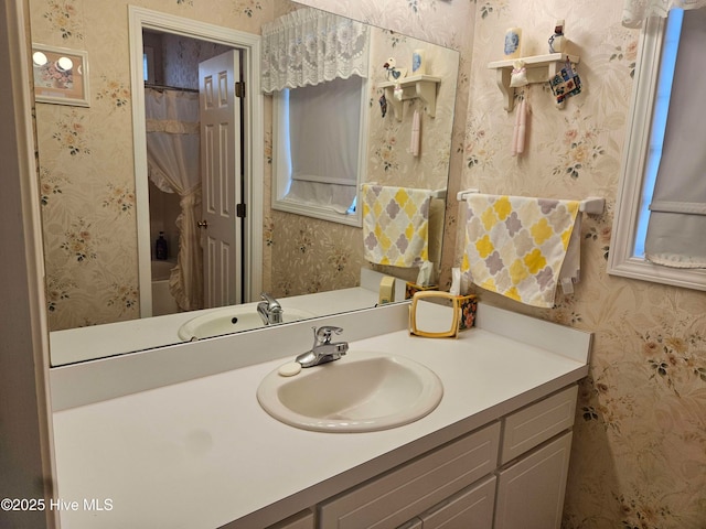 bathroom with wallpapered walls, vanity, and a shower with shower curtain