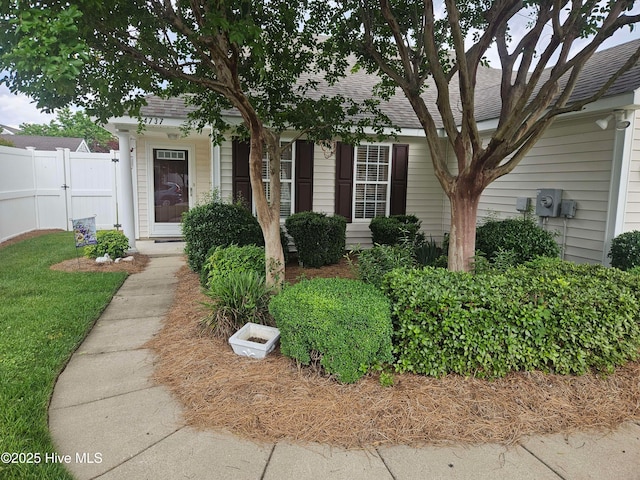 view of front of home featuring fence and a shingled roof