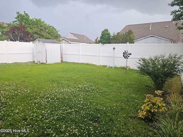 view of yard featuring a storage shed and an outbuilding