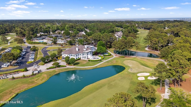 aerial view of property and surrounding area with a large body of water and a golf club