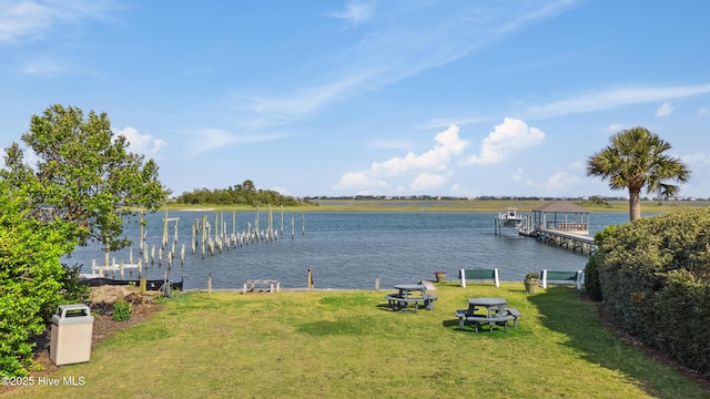 dock area featuring a lawn and a water view