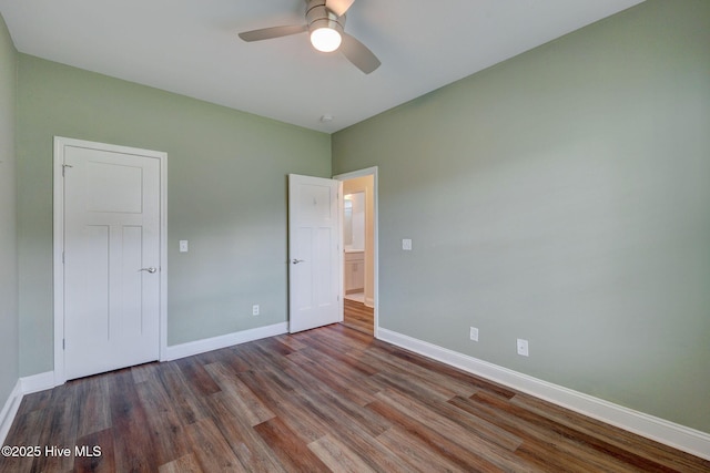 unfurnished bedroom featuring wood finished floors, baseboards, and ceiling fan