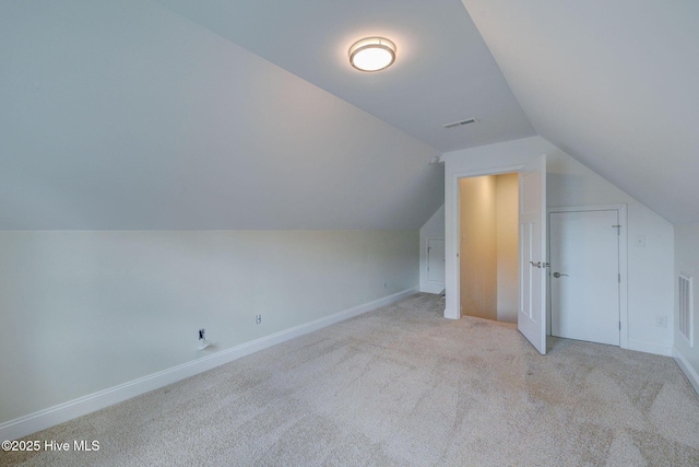 bonus room featuring lofted ceiling, carpet flooring, and baseboards