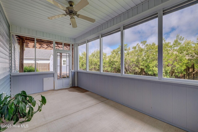 unfurnished sunroom featuring a ceiling fan