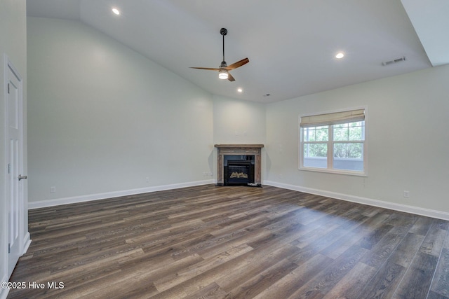 unfurnished living room featuring vaulted ceiling, ceiling fan, dark wood finished floors, recessed lighting, and a fireplace with flush hearth