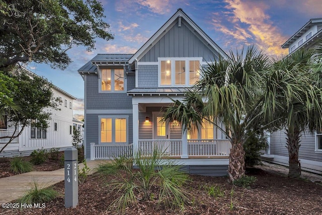 214 Writers Way, Bald Head Island, NC 28461 - view of front of property with covered porch and board and batten siding