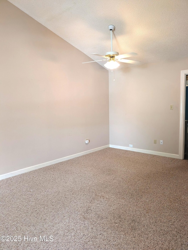 spare room with ceiling fan, carpet floors, a textured ceiling, and baseboards
