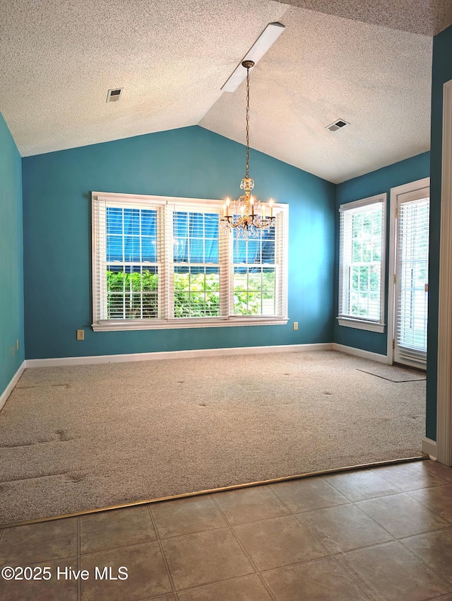 unfurnished dining area with carpet flooring, lofted ceiling, a chandelier, baseboards, and a textured ceiling