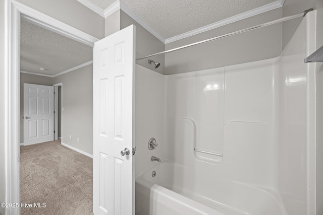 bathroom featuring a textured ceiling, crown molding, tub / shower combination, and baseboards