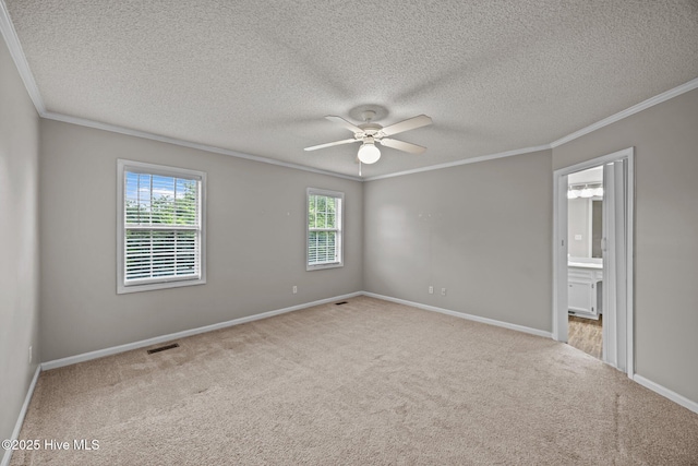 unfurnished room featuring crown molding, a ceiling fan, carpet floors, a textured ceiling, and baseboards