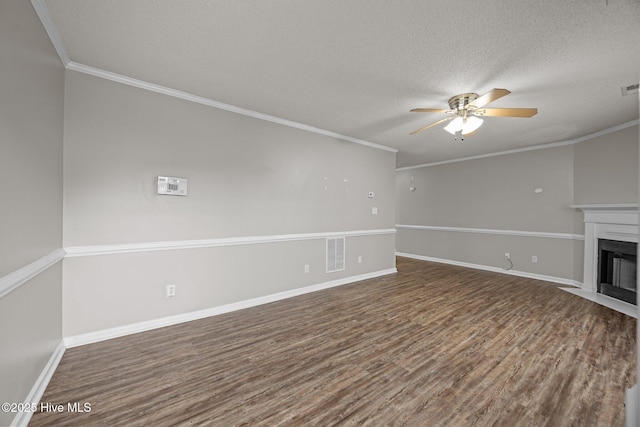 unfurnished living room with wood finished floors, a ceiling fan, a fireplace with flush hearth, a textured ceiling, and baseboards