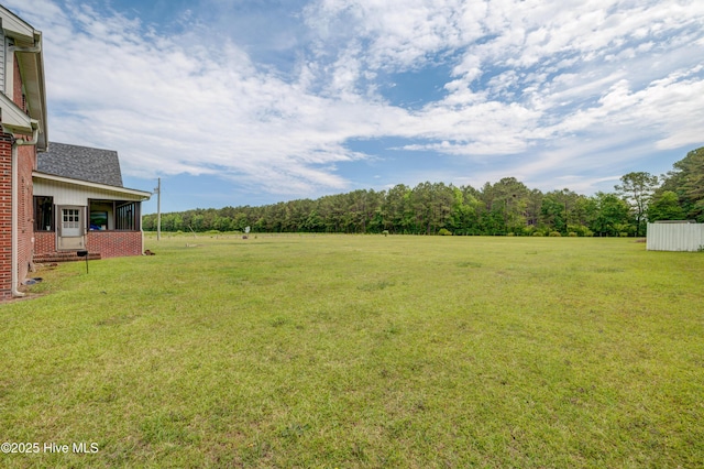 15554 US Highway 421, Burgaw, NC 28425 - view of green lawn featuring a sunroom and a view of trees