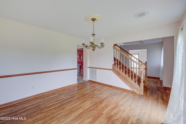 15554 US Highway 421, Burgaw, NC 28425 - unfurnished room featuring a chandelier, wood finished floors, stairway, and baseboards