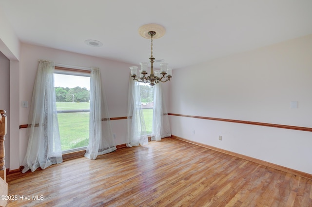 15554 US Highway 421, Burgaw, NC 28425 - empty room with a chandelier, light wood-style floors, and baseboards