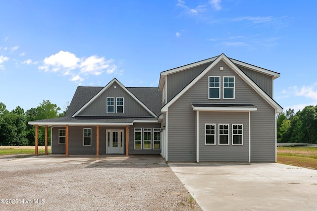 view of front of home featuring concrete driveway and roof with shingles