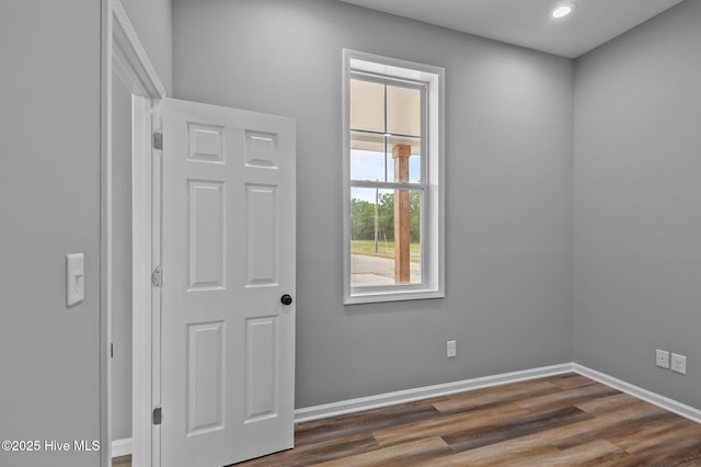 unfurnished room with baseboards, dark wood-style floors, and recessed lighting