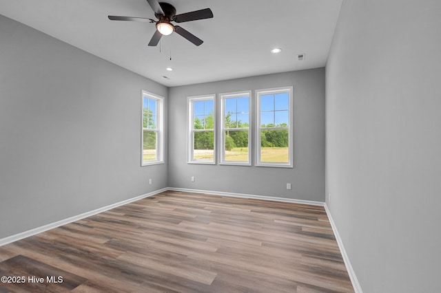 unfurnished room with a ceiling fan, baseboards, recessed lighting, and wood finished floors