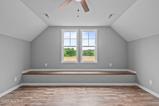 bonus room featuring a ceiling fan, lofted ceiling, wood finished floors, and baseboards