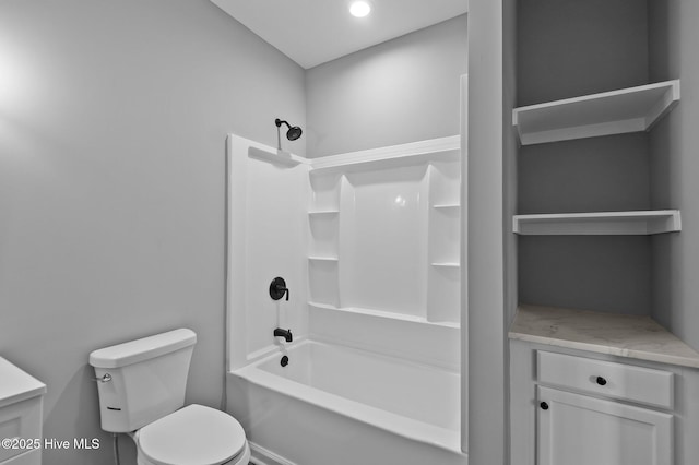 bathroom featuring toilet, shower / washtub combination, and vanity