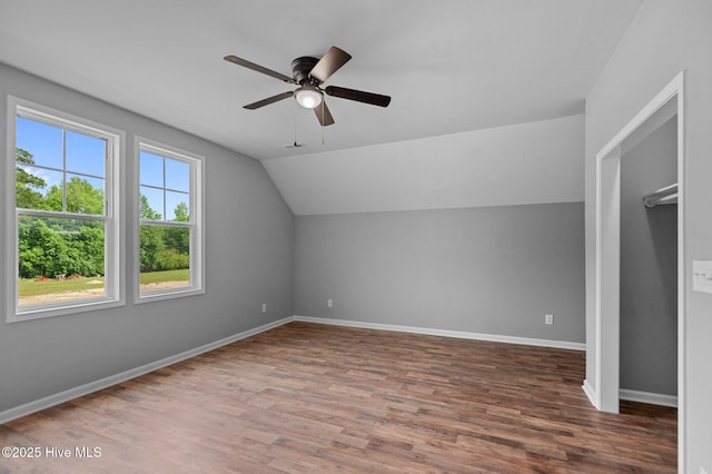 additional living space featuring ceiling fan, lofted ceiling, wood finished floors, and baseboards