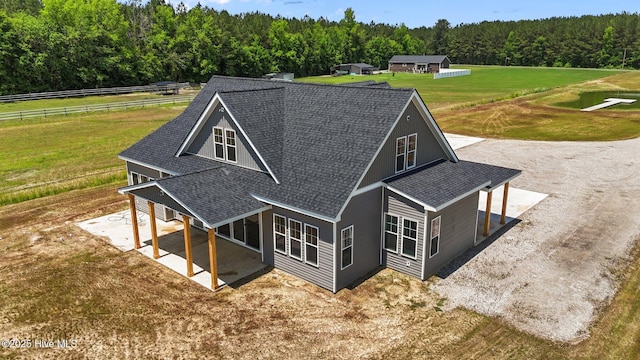 aerial view of property and surrounding area featuring a heavily wooded area