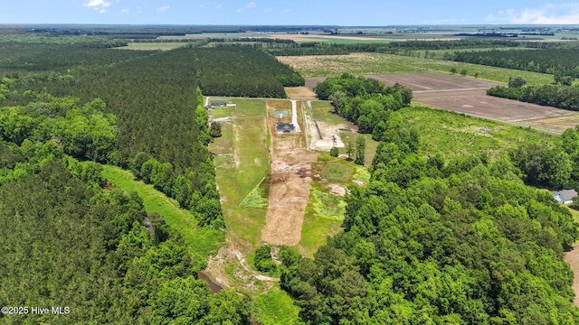 aerial view of property and surrounding area with rural landscape, a forest, and farmland