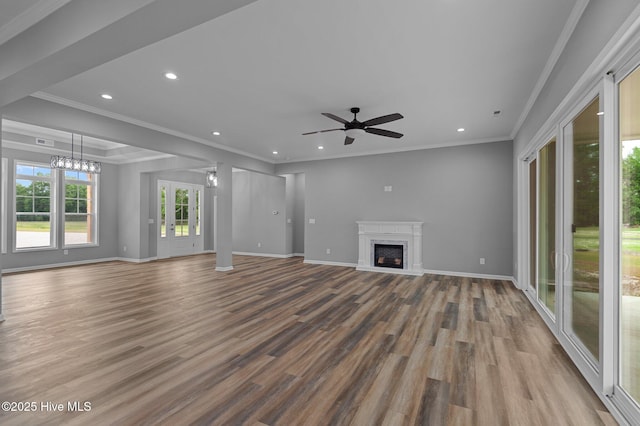 unfurnished living room with wood finished floors, a ceiling fan, a fireplace, recessed lighting, and crown molding