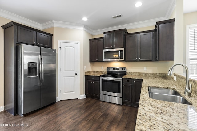 202 Bungalow Rd, Holly Ridge, NC 28445 - kitchen with stainless steel appliances, a sink, light stone counters, dark wood-style floors, and dark brown cabinetry