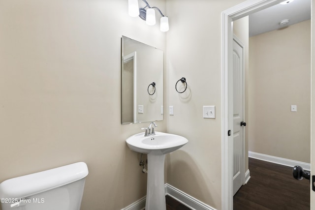 202 Bungalow Rd, Holly Ridge, NC 28445 - half bath featuring baseboards, toilet, and wood finished floors