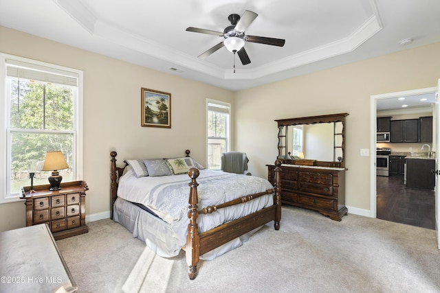 202 Bungalow Rd, Holly Ridge, NC 28445 - carpeted bedroom with a raised ceiling, a sink, multiple windows, ornamental molding, and baseboards