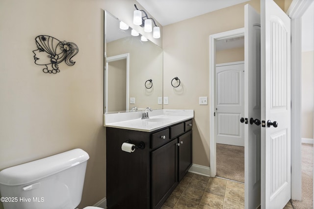 202 Bungalow Rd, Holly Ridge, NC 28445 - half bathroom featuring baseboards, vanity, and toilet