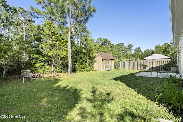 202 Bungalow Rd, Holly Ridge, NC 28445 - view of yard with a shed, an outdoor structure, a patio, and view of scattered trees