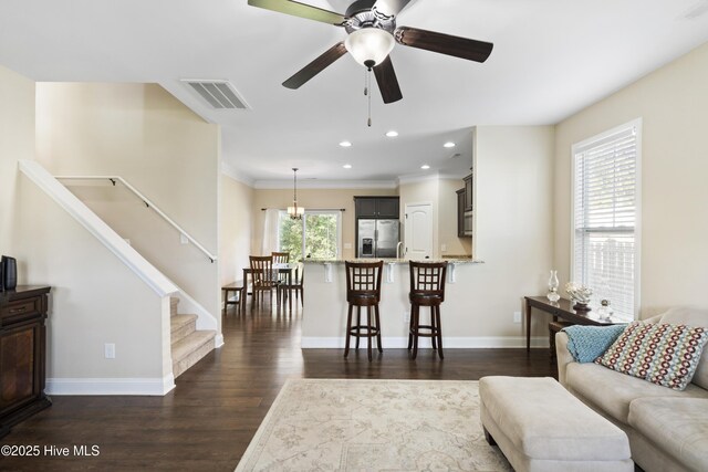 202 Bungalow Rd, Holly Ridge, NC 28445 - living room with dark wood-style floors, baseboards, recessed lighting, ceiling fan, and stairs