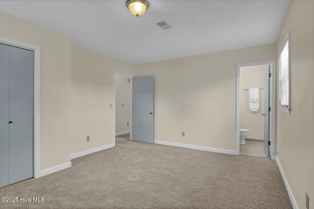 805 Hamlet Ave, Carolina Beach, NC 28428 - unfurnished bedroom featuring carpet flooring, ensuite bathroom, baseboards, and a closet