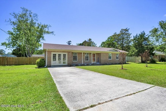 805 Hamlet Ave, Carolina Beach, NC 28428 - single story home featuring french doors, driveway, and brick siding