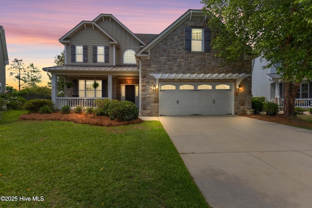 5613 Swiss Stone Ct, Wilmington, NC 28412 - craftsman-style home with a porch, board and batten siding, concrete driveway, a front yard, and a garage