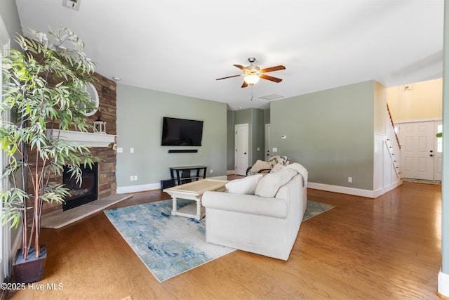 5613 Swiss Stone Ct, Wilmington, NC 28412 - living area featuring a fireplace, a ceiling fan, wood finished floors, and baseboards