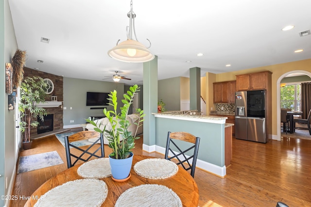 5613 Swiss Stone Ct, Wilmington, NC 28412 - dining space featuring wood finished floors, a fireplace, a ceiling fan, recessed lighting, and baseboards