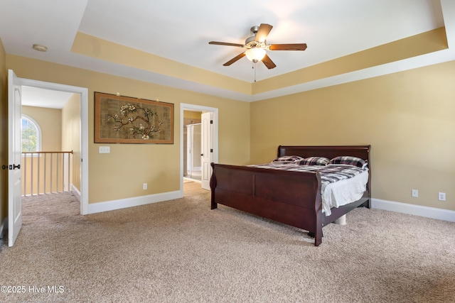 5613 Swiss Stone Ct, Wilmington, NC 28412 - bedroom with a raised ceiling, carpet flooring, baseboards, ceiling fan, and connected bathroom