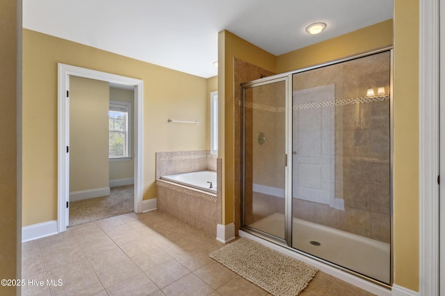 5613 Swiss Stone Ct, Wilmington, NC 28412 - full bathroom with tile patterned flooring, a stall shower, a garden tub, and baseboards