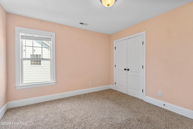 5613 Swiss Stone Ct, Wilmington, NC 28412 - unfurnished bedroom featuring carpet flooring, a closet, and baseboards
