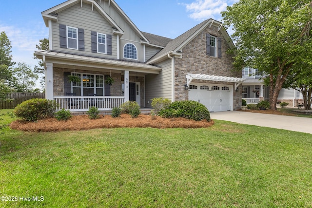 5613 Swiss Stone Ct, Wilmington, NC 28412 - view of front facade with stone siding, covered porch, concrete driveway, a standing seam roof, and board and batten siding