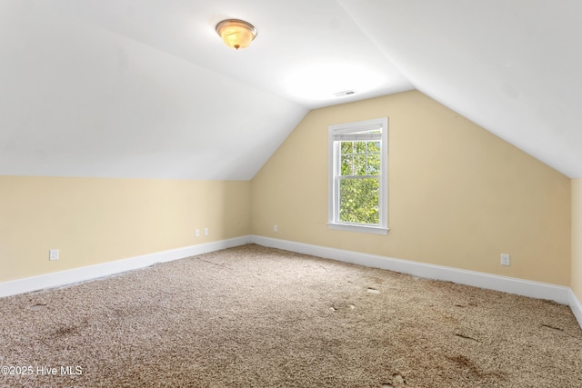 5613 Swiss Stone Ct, Wilmington, NC 28412 - additional living space with vaulted ceiling, carpet flooring, and baseboards