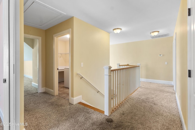 5613 Swiss Stone Ct, Wilmington, NC 28412 - hallway featuring carpet flooring, attic access, an upstairs landing, and baseboards