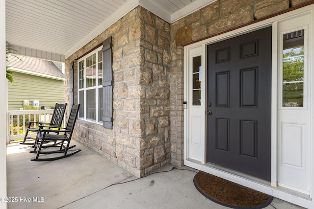 5613 Swiss Stone Ct, Wilmington, NC 28412 - doorway to property with covered porch and stone siding