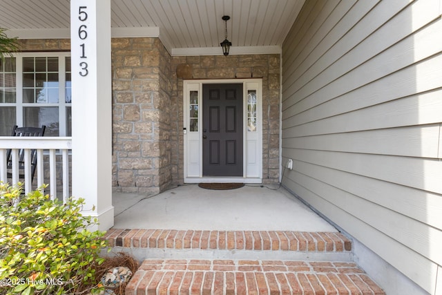 5613 Swiss Stone Ct, Wilmington, NC 28412 - entrance to property with a porch and stone siding