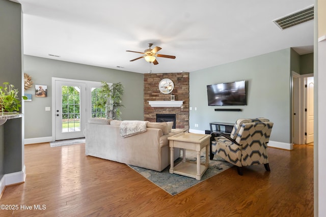 5613 Swiss Stone Ct, Wilmington, NC 28412 - living area with a ceiling fan, baseboards, a stone fireplace, and wood finished floors