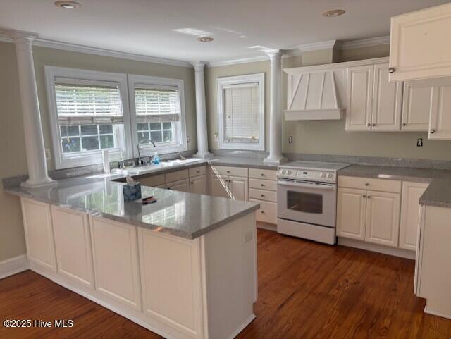 314 Madam Moores Ln, New Bern, NC 28562 - kitchen featuring white electric stove, custom range hood, ornate columns, a peninsula, and crown molding