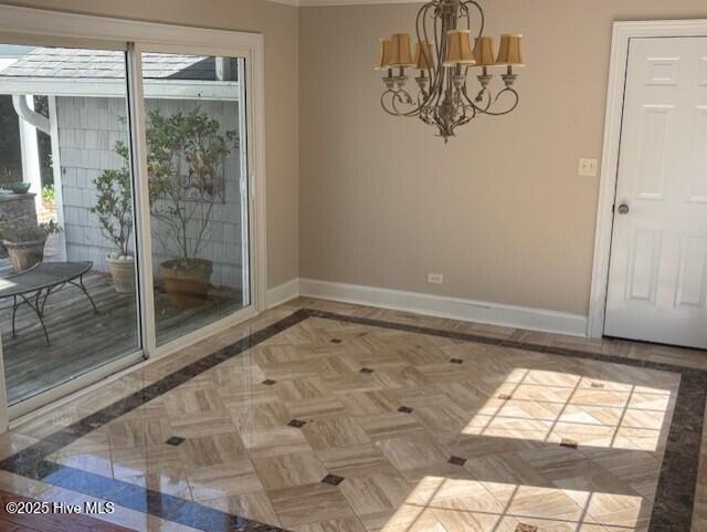 314 Madam Moores Ln, New Bern, NC 28562 - unfurnished dining area featuring baseboards and a chandelier